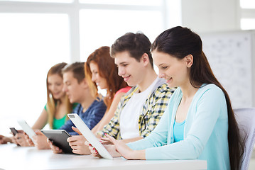 Image showing smiling students with tablet pc at school