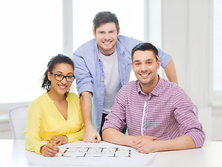 Image showing three smiling architects working in office