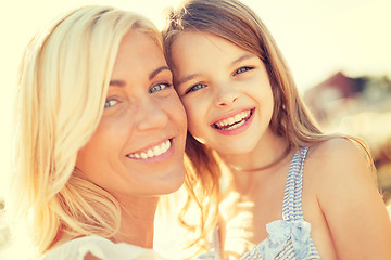 Image showing happy mother and child girl outdoors