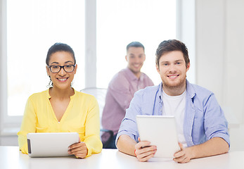 Image showing smiling team with tablet pc computers at office