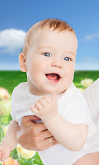 Image showing close up of mother holding smiling baby