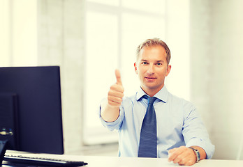 Image showing smiling businessman showing thumbs up