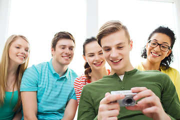 Image showing smiling students with digital camera at school