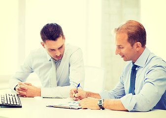 Image showing businessmen with notebook on meeting