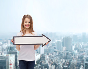 Image showing smiling girl with blank arrow pointing right