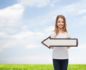 Image showing smiling girl with blank arrow pointing left