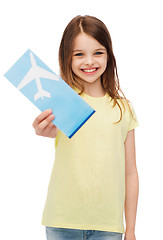 Image showing smiling little girl with airplane ticket