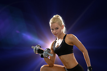 Image showing young sporty woman with heavy steel dumbbell
