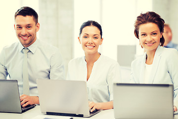 Image showing group of people working with laptops in office