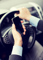 Image showing man using phone while driving the car