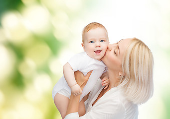 Image showing happy mother kissing smiling baby