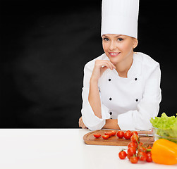 Image showing smiling female chef with vegetables