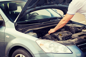 Image showing man opening car bonnet