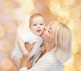 Image showing happy mother kissing smiling baby