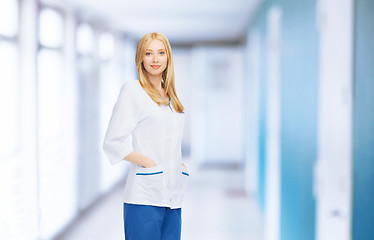 Image showing smiling female doctor or nurse in medical facility
