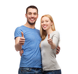 Image showing smiling couple showing thumbs up