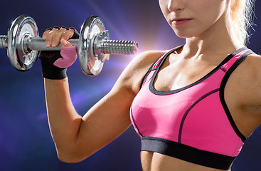 Image showing close up of sporty woman with heavy steel dumbbell