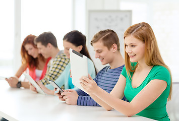 Image showing smiling students with tablet pc at school