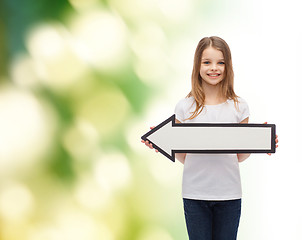 Image showing smiling girl with blank arrow pointing left