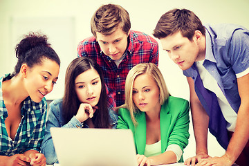 Image showing international students looking at laptop at school