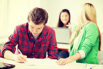 Image showing students writing something at school