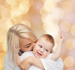 Image showing happy mother kissing smiling baby