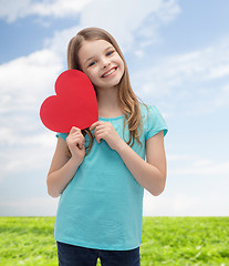 Image showing smiling little girl with red heart