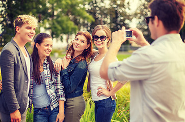 Image showing teenagers taking photo with digital camera outside