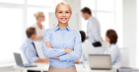 Image showing young smiling businesswoman with crossed arms