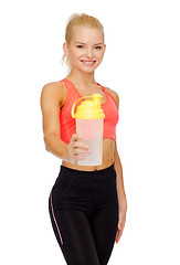 Image showing smiling sporty woman with protein shake bottle