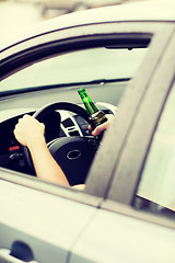 Image showing man drinking alcohol while driving the car