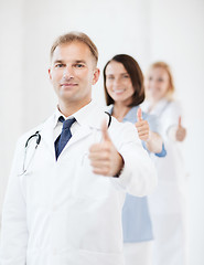 Image showing doctor with stethoscope and colleagues