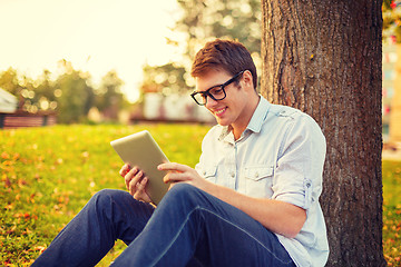 Image showing smiling male student in eyeglasses with tablet pc