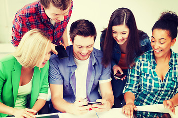 Image showing students looking into smartphone at school