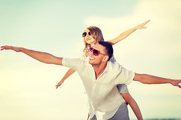 Image showing happy father and child in sunglasses over blue sky