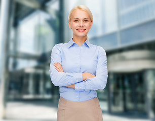 Image showing young smiling businesswoman with crossed arms