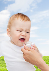 Image showing crying baby with dummy