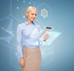 Image showing smiling woman looking at tablet pc computer