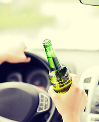 Image showing man drinking alcohol while driving the car