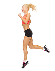 Image showing sporty woman running or jumping