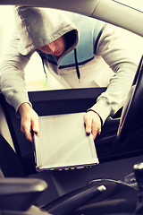 Image showing thief stealing laptop from the car