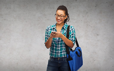 Image showing student in eyeglasses with smartphone and bag