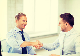 Image showing businessmen shaking hands in office