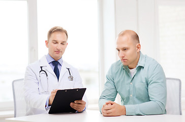 Image showing doctor with clipboard and patient in hospital