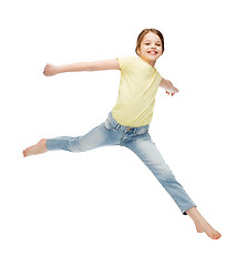 Image showing smiling little girl jumping