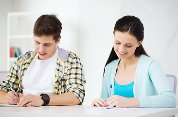 Image showing smiling students with textbooks at school