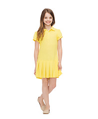 Image showing smiling little girl in yellow dress