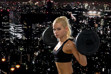 Image showing sporty woman exercising with barbell