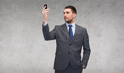 Image showing young businessman with smartphone