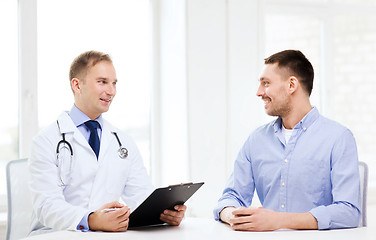 Image showing doctor with clipboard and patient in hospital